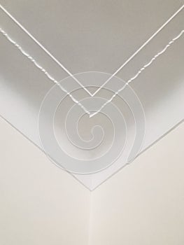 Small wave pattern crown molding in luxury home ceiling. Ornamental at the corner. Vertical photo image.