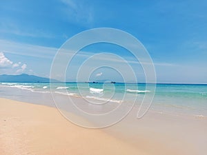 Small wave sea and sandy beach under the bright blue sky in Canh Ranh, Vietnam