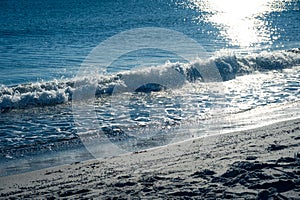 Small waves crashing into sand beach during winter in Skåne Sweden