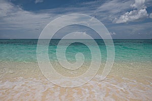 Small waves lap the pristine sands on Cayman Island in the British West Indies