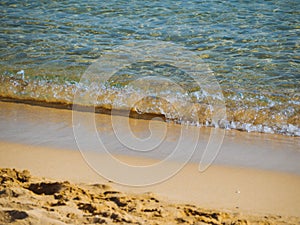 Small waves on a nice empty sandy beach - crystal clear water