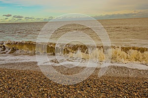 Small waves rolling in on the shingle beach