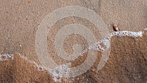 Small waves on the sandy beach