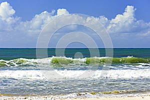 Small waves on the shore on a sunny summer day