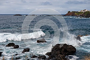 Small waves splashing the volcanic rocks in Atlantic Ocean in Mosteiros Azores