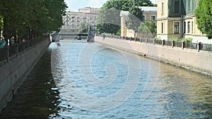 Small waves spreading out flowing water in the city channel