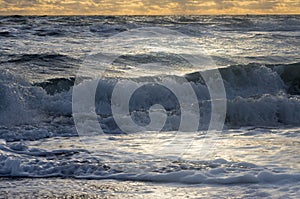 Small waves in a troubled sea roll to shore