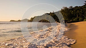 Small waves and white beach at Seychelles islands. Mahe, Anse Takamaka