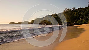 Small waves and white beach at Seychelles islands. Mahe, Anse Takamaka