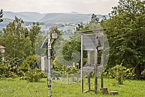Small weather station on a green meadow