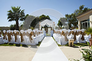 Small wedding tent in garden with chairs on lawn