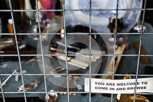 Small Welcome to Browse sign seen attached to an antique shop window.