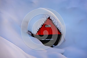 Small well with name Zofka with a red house in a snowy landscape