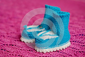 Small white-blue children`s knitted booties