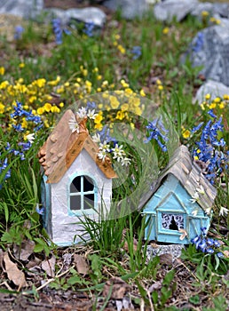 Small white and blue fairy houses in magic garden