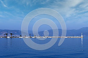 small white boats and blue sea in the harbor Nafplio