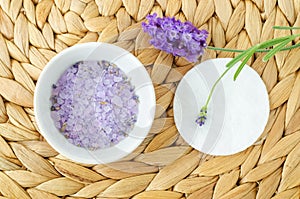 Small white bowl with purple lavender crystal bath salt foot soak. Homemade pedicure, spa and beauty treatment recipe