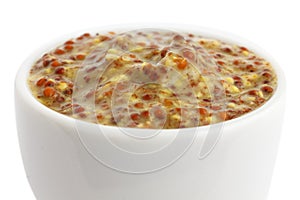 Small white ceramic dish of French dijon mustard.