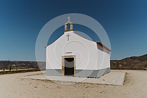 Small white chapel in Torre de Moncorvo in Portugal under blue sky photo