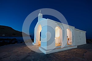 Small white church Saint Nicholas in the sea, Georgioupoli, Crete.