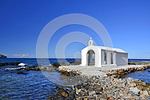 Small white church Saint Nikolaos in the sea, Crete