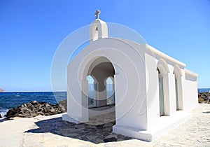 Small white church in sea , Crete, Greece