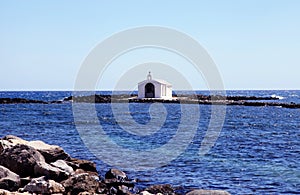 Small white church in sea near Georgioupolis, Crete, Greece