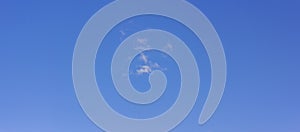 A small white cloud in the blue sky