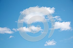 Small white clouds on light blue clear sky