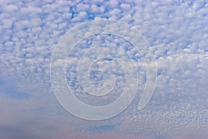 Small white cumulus clouds in blue sky