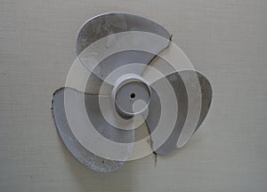 Small white fan with 4-blade propeller repair