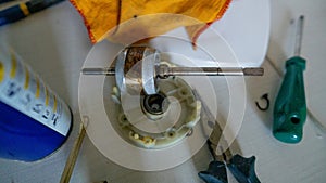 Small white fan with 4-blade propeller repair