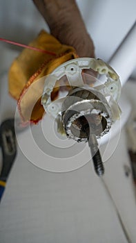 Small white fan with 4-blade propeller repair