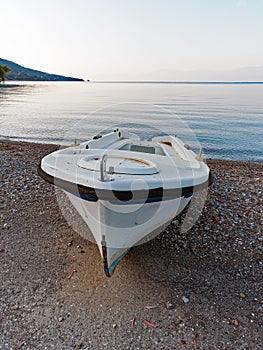 Small White Fishing Boat on Pebbly Beach, Greece