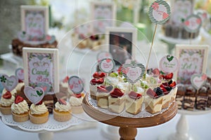 Small white and green cakes at a wedding candy bar