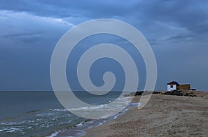 Small white house on the bank of a sand spit