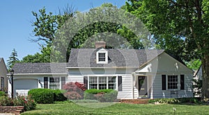 Small White House with One Dormer and Black Shutters