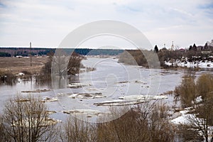 Small white ice floes float down the river. Spring, snow melts