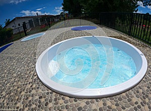 small white jacuzzi with blue water