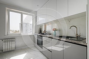 Small White modern domestic kitchen interior with furniture