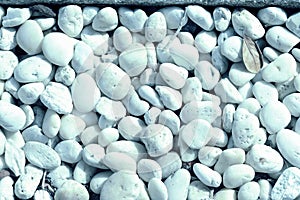 Small white pebbles texture closeup. Natural background blue color toned