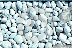 Small white pebbles texture closeup. Natural background blue color toned