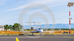 Small white private jet parked in airport