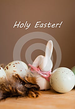 Small white rabbit figurine with easter eggs