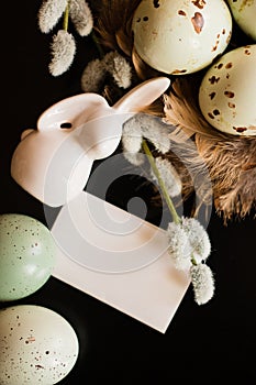 Small white rabbit figurine with easter eggs