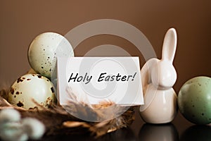 Small white rabbit figurine with easter eggs