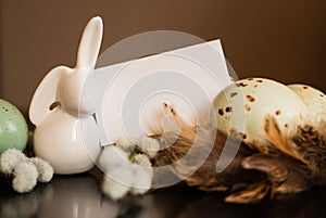 Small white rabbit figurine with easter eggs
