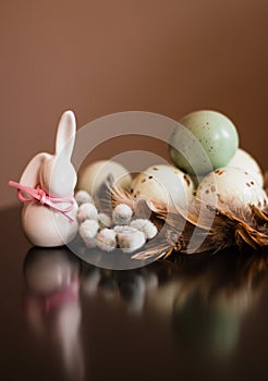Small white rabbit figurine with easter eggs