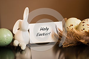 Small white rabbit figurine with easter eggs