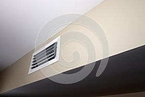 Small White Rectangle Air Vent in a Wall of a Home HVAC System